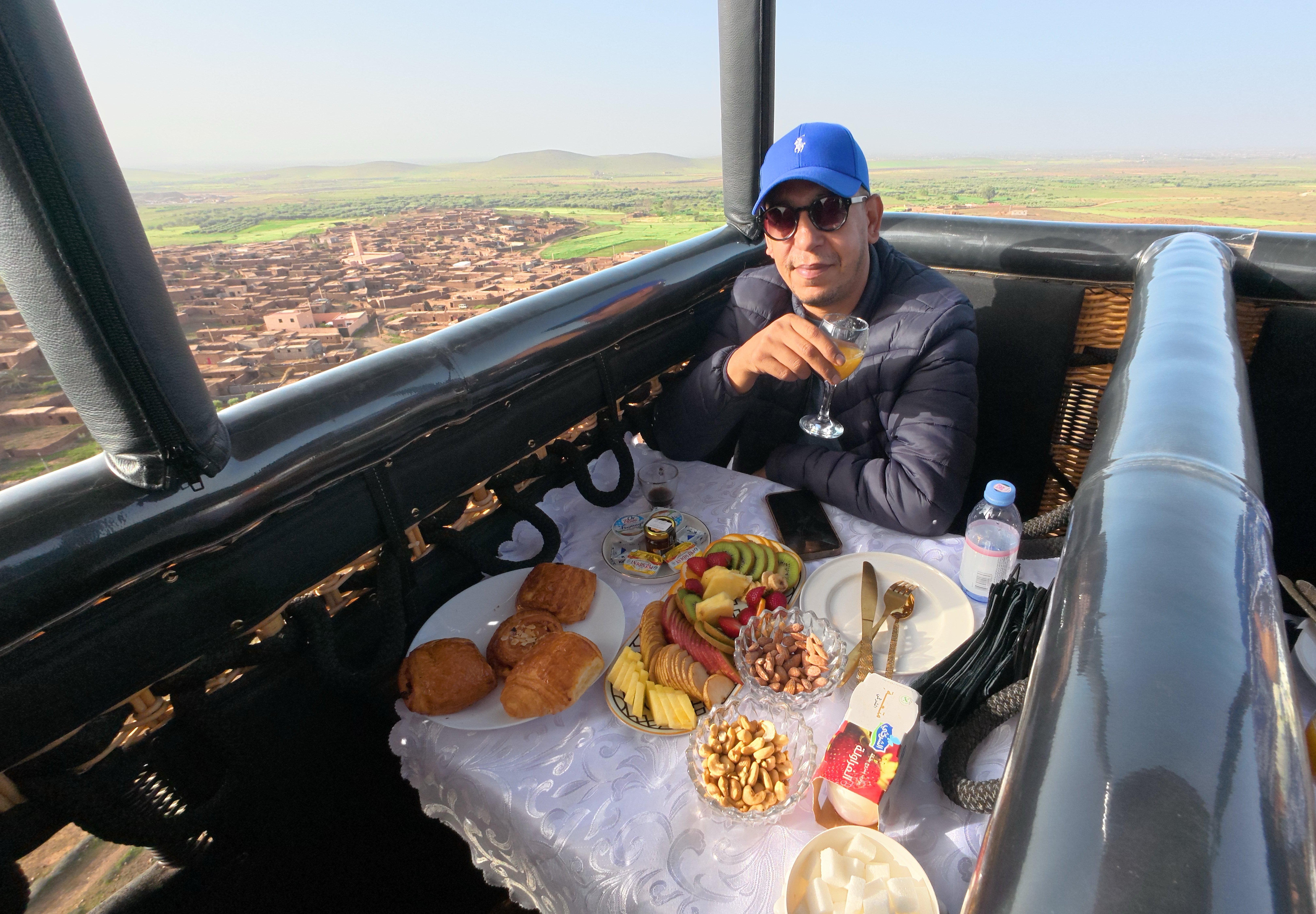 Guests in a balloon basket over countryside near Marrakech