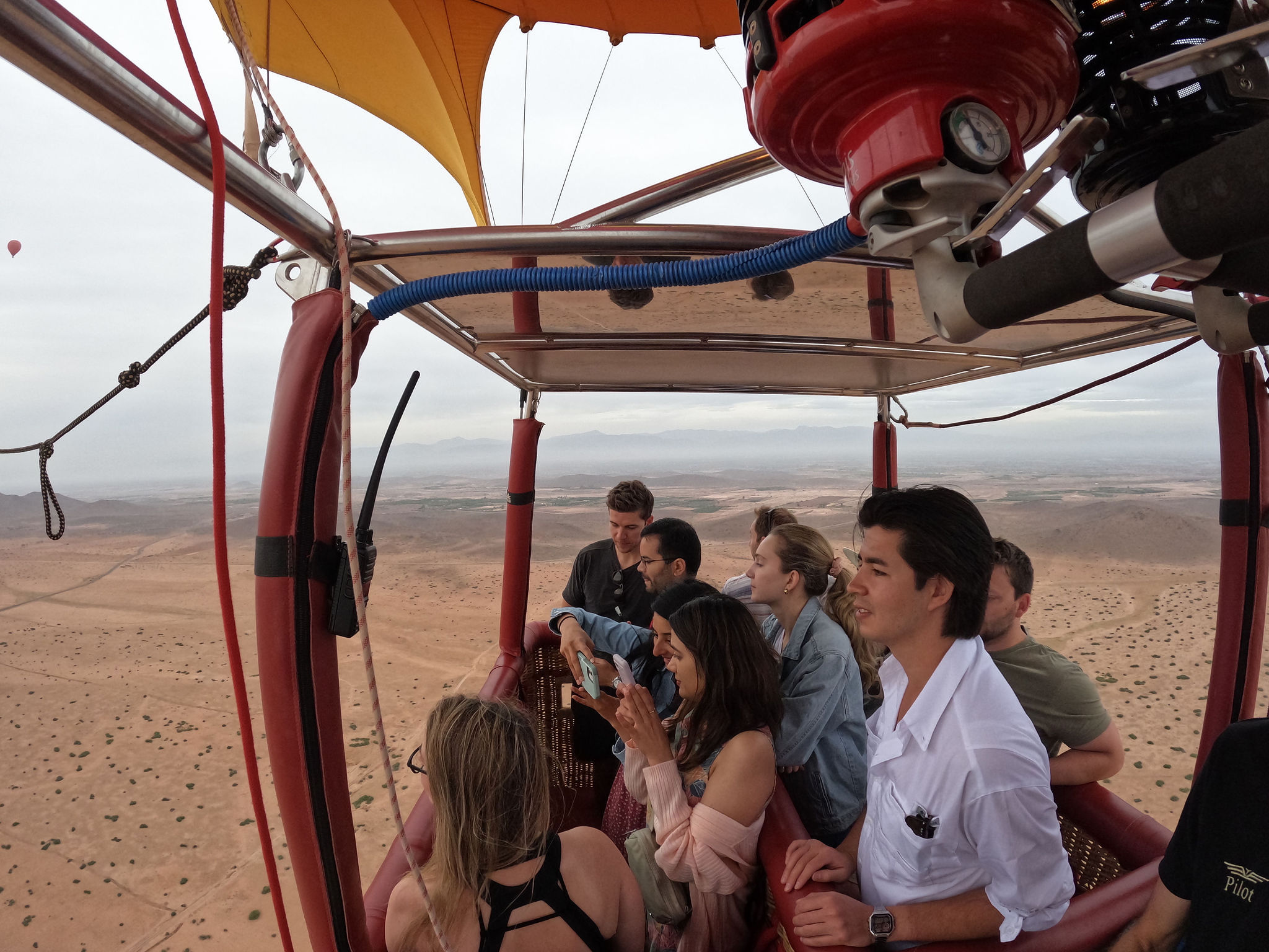 Guests looking out from a balloon basket over the Marrakech plain