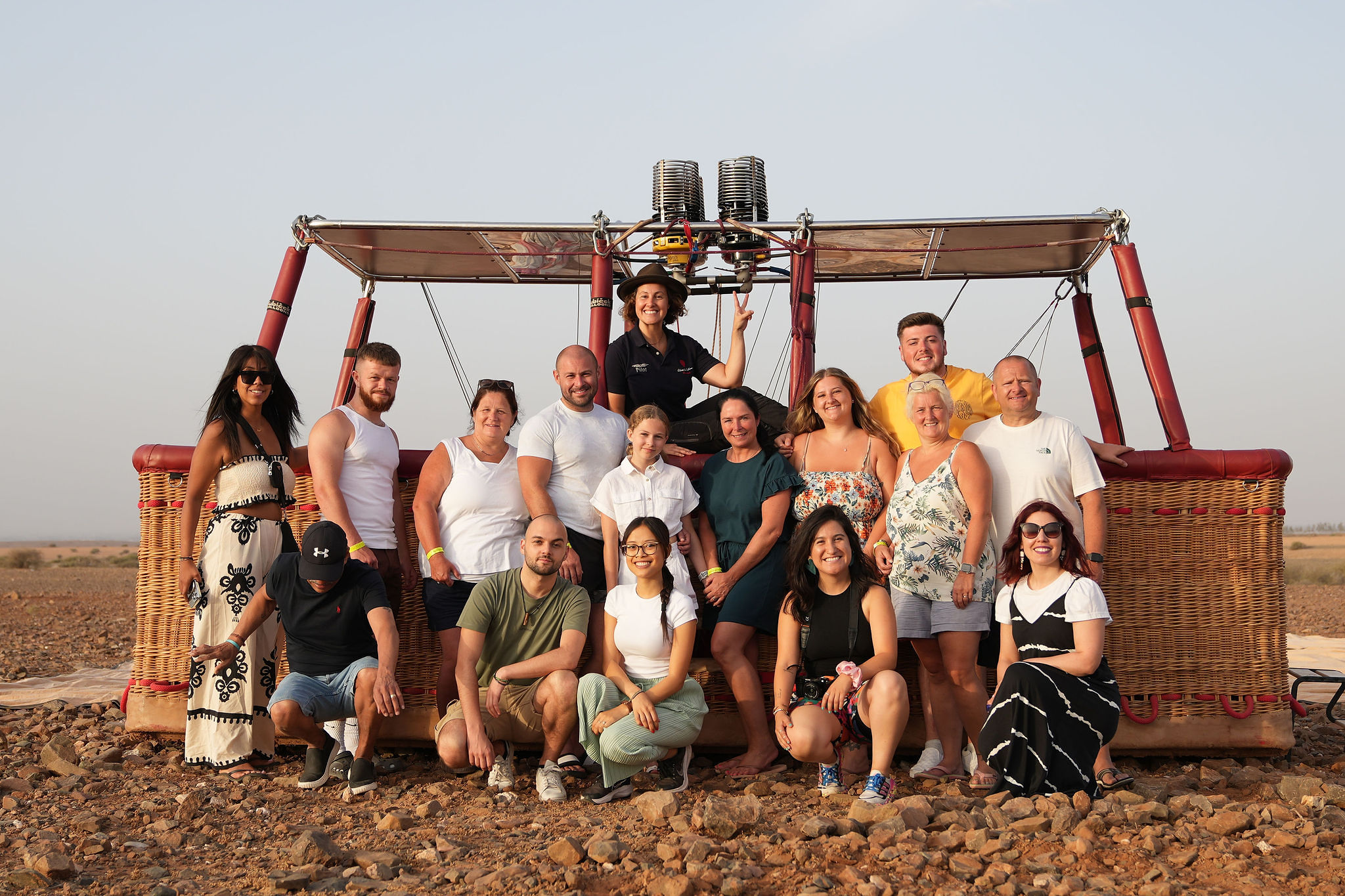 Guests and the pilot with the basket after landing, envelope packed on the ground