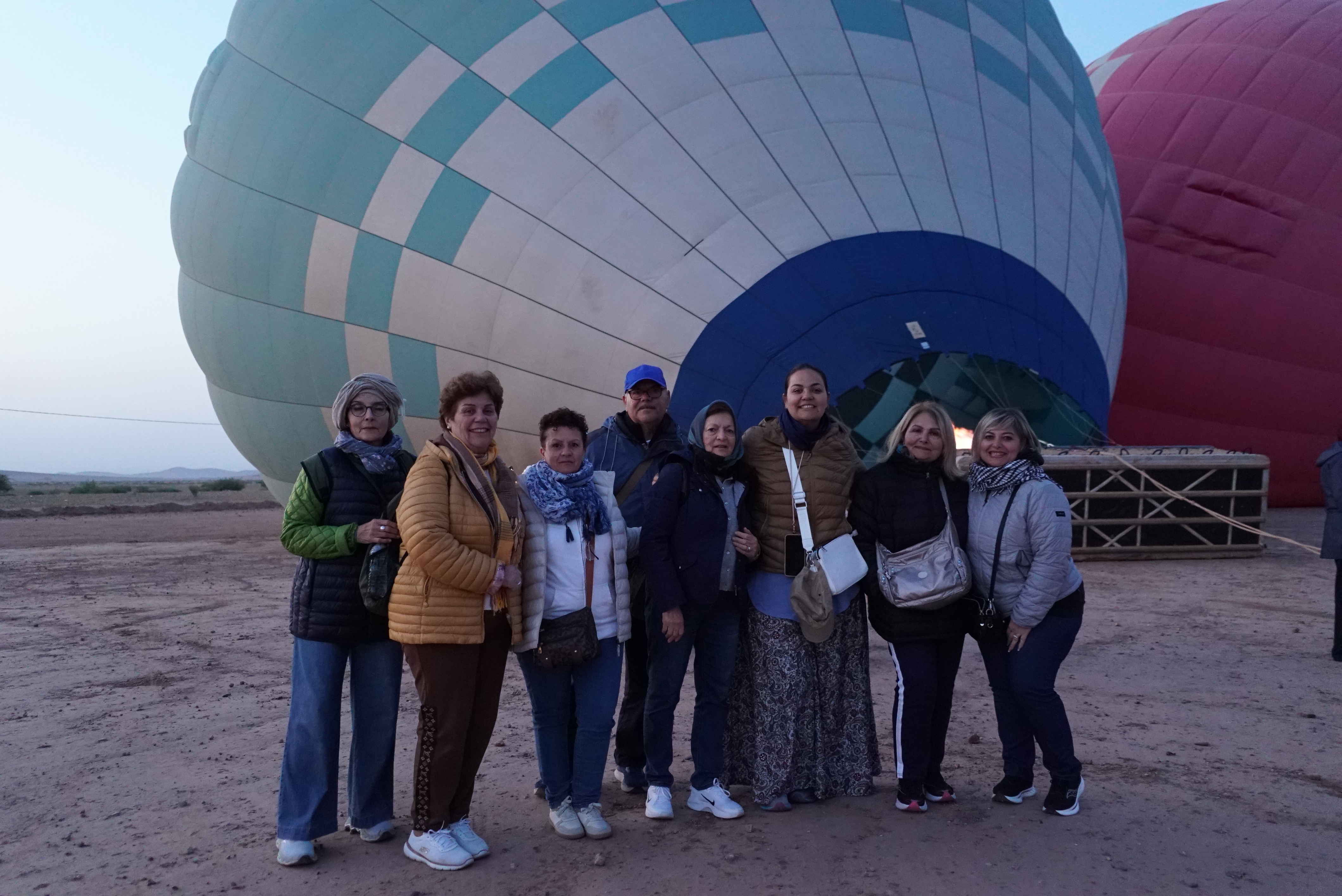 Guests standing in front of balloons being inflated at dawn