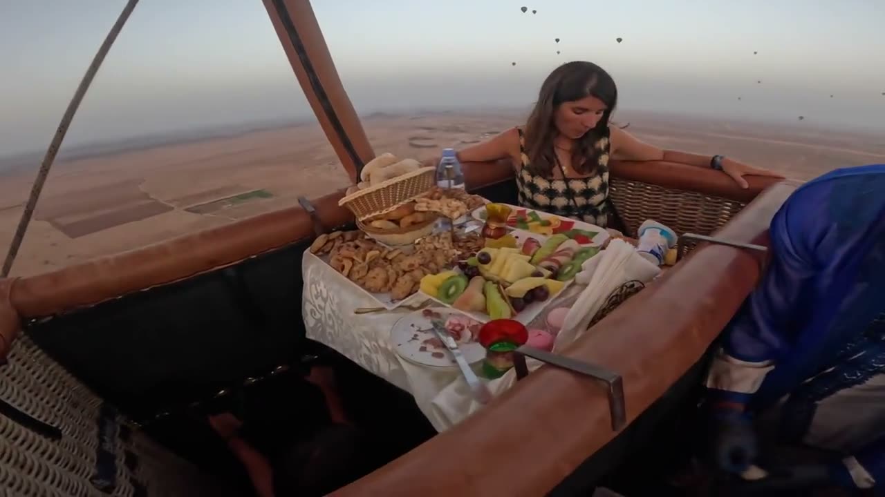 Breakfast being served in a small balloon basket over the Marrakech plain